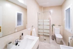 a bathroom with a sink and a toilet and a shower at Expoholidays - General Tamayo PARKING gratis in Almería
