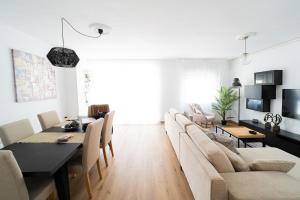 Una sala de estar con mesa de comedor y sillas. en Expoholidays - General Tamayo PARKING gratis, en Almería