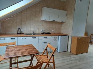 a kitchen with a table and chairs and a sink at Willa Rudenka in Rudenka