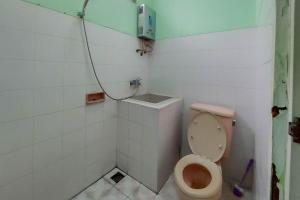 a bathroom with a toilet and a shower at Villa Getsemani Mitra RedDoorz in Sangkanurip