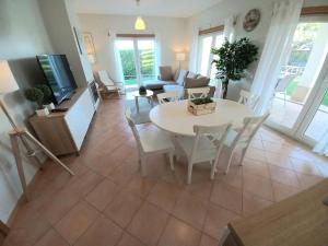 a living room with a white table and chairs at Casa da Praia in Sagres
