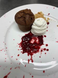 a plate of food with a chocolate cupcake and a desert at Albergo Castiglione Langhe in Castiglione Tinella