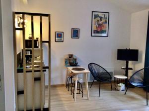 a living room with a small table and chairs at La Foulonnière de Neuville in Neuville-sur-Saône