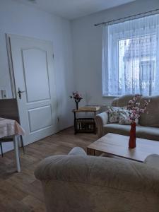 a living room with two couches and a table at Ferienwohnung in der Altstadt von Coswig Anhalt in Coswig