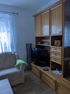 a living room with a couch and a flat screen tv at Ferienwohnung in der Altstadt von Coswig Anhalt in Coswig