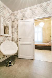 a room with a white chair and a bedroom at Parliment Luxury Apartment in Budapest