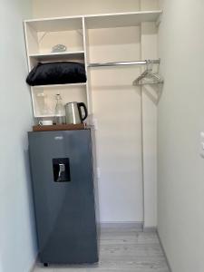 a small refrigerator in a corner of a room at Constanza Lofts Executives en Zapopan Jalisco in Guadalajara