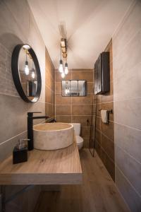 a bathroom with a round sink and a mirror at Entre Loire et Sologne Maison d'hôtes in Saint-Gervais-la-Forêt
