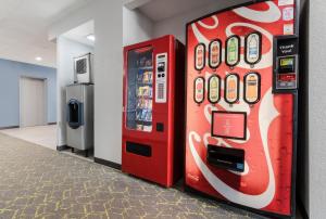 a red vending machine next to a soda machine at HomeTowne Studios by Red Roof Newport News - Hampton West in Newport News