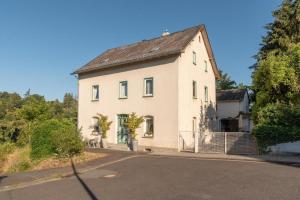 a large white house on the side of a road at Lahnhaus Brühl/ Fende Haus in Arfurt