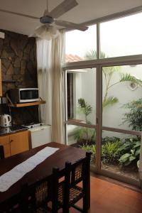 a dining room with a table and a large window at Departamentos Ibazeta in Salta +50 photos
