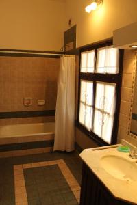 a bathroom with a shower and a sink and a tub at Departamentos Ibazeta in Salta