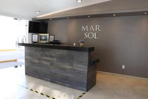 a room with a wooden floor and a black counter top at Mar Sol Bungalows & Hotel in Mazatlán