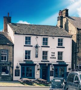 a white building with a sign that reads the law house at The Bay Horse, Masham in Masham