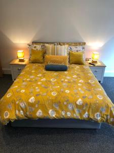 a bedroom with a bed and a lamp at Marine Villa Hotel & Suites - Close to Beach, Train Station & Southend Airport in Southend-on-Sea