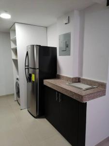 a kitchen with a black and stainless steel refrigerator at 2 room department (5 people). Private exclusive area in Guayaquil in Guayaquil