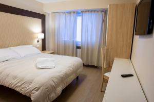 Letto o letti in una camera di Hotel Hermitage