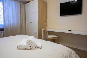 Letto o letti in una camera di Hotel Hermitage