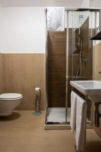 a bathroom with a shower and a sink and a toilet at Hotel Hermitage in Sestriere
