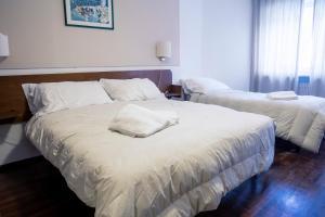 Letto o letti in una camera di Hotel Hermitage