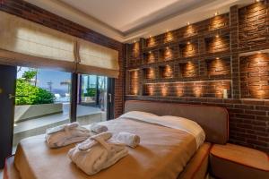 a bedroom with a bed with towels on it at KingsResidenceVilla in Nafplio +53 photos