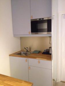 a kitchen with a sink and a microwave at Avanti Apartment Hotel in Stockholm