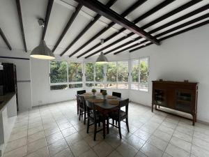 a dining room with a table and chairs and windows at MULAGUA in Agulo