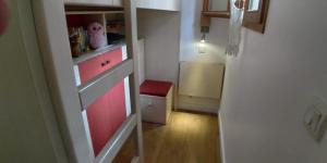 a small kitchen with a red cabinet in a room at Studio cabine vue mer, piscine panoramique, parking couvert in Cannes