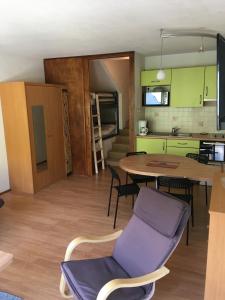 a kitchen and dining room with a table and chairs at La Mongie, apt 30m2 centre station in Bagnères-de-Bigorre