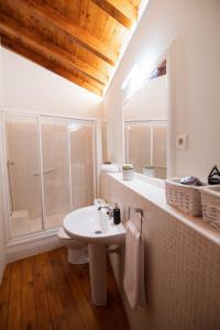 a bathroom with a white sink and a window at El Postigo in Trujillo