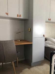a room with a desk and a bed with a lamp at Avanti Apartment Hotel in Stockholm