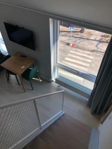 a room with a window and a desk and a television at Avanti Apartment Hotel in Stockholm