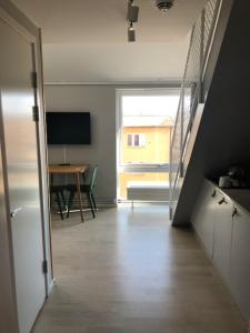 a hallway leading to a room with a table and a door at Avanti Apartment Hotel in Stockholm