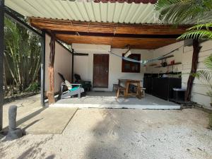 a patio of a house with a table and chairs at Beach Cabinas in Santa Teresa Beach