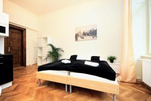 Schlafzimmer mit einem Bett mit schwarzer Bettwäsche in der Unterkunft PEACEFUL COUPLE STAY / OLD TOWN / JEWISH QUARTER in Prag