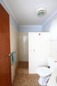 a bathroom with a toilet and a sink at Albatross Motor Inn in Lakes Entrance