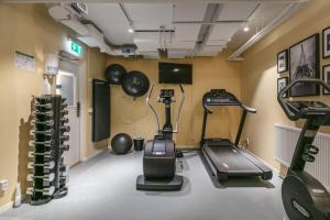 a room with a gym with a treadmill and weights at Avanti Apartment Hotel in Stockholm