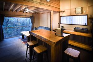 a kitchen with a large wooden island in a room at The Shack in Hakuba