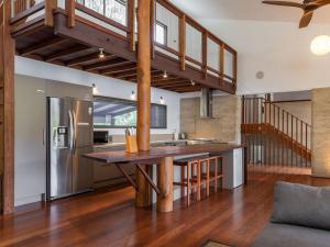 an open kitchen with a wooden island in a house at Dux Nutz in Smiths Lake