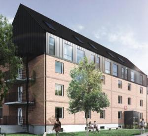 a large brick building with a black roof at Avanti Apartment Hotel in Stockholm