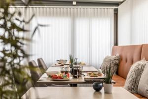 a table with plates of food on top of it at Avanti Apartment Hotel in Stockholm