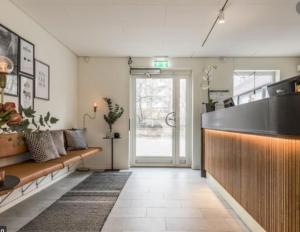a living room with a couch and a table at Avanti Apartment Hotel in Stockholm