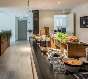 a buffet line in a restaurant with food on it at Avanti Apartment Hotel in Stockholm