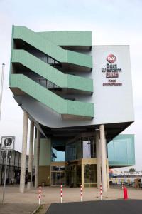 a building with a sign on the side of it at Best Western Plus Hotel Bremerhaven in Bremerhaven