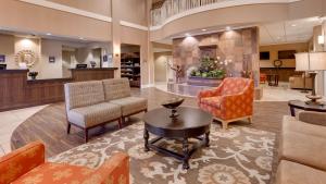a lobby of a hotel with chairs and a table at Best Western Plus Chandler Hotel & Suites in Chandler