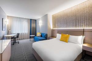a hotel room with a large bed and a large window at Radisson Blu Plaza Hotel Sydney in Sydney