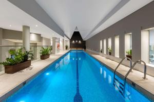 a swimming pool with a pool table and chairs at Radisson Blu Plaza Hotel Sydney in Sydney