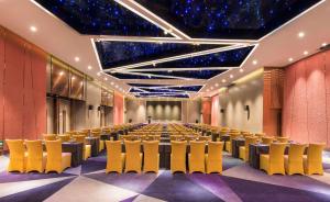 a conference room with rows of tables and chairs at Radisson Blu Shanghai Pudong Jinqiao in Shanghai