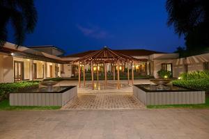 een huis met een groot prieel ervoor bij Radisson Blu Resort & Spa Alibaug in Alibaug