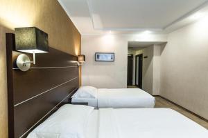 Ένα ή περισσότερα κρεβάτια σε δωμάτιο στο Park Inn by Radisson Sadu